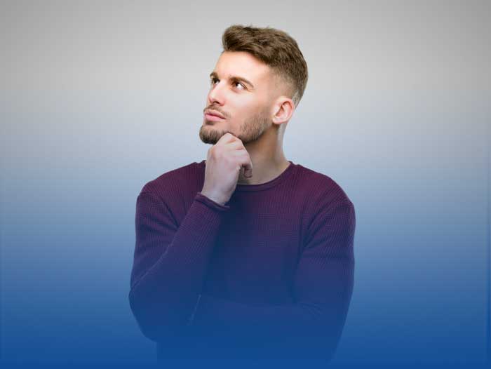 A young man contemplating if bridging finance or a bridging loan is appropriate.