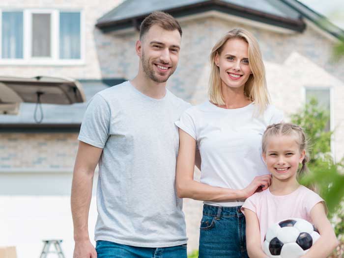 family in front of home